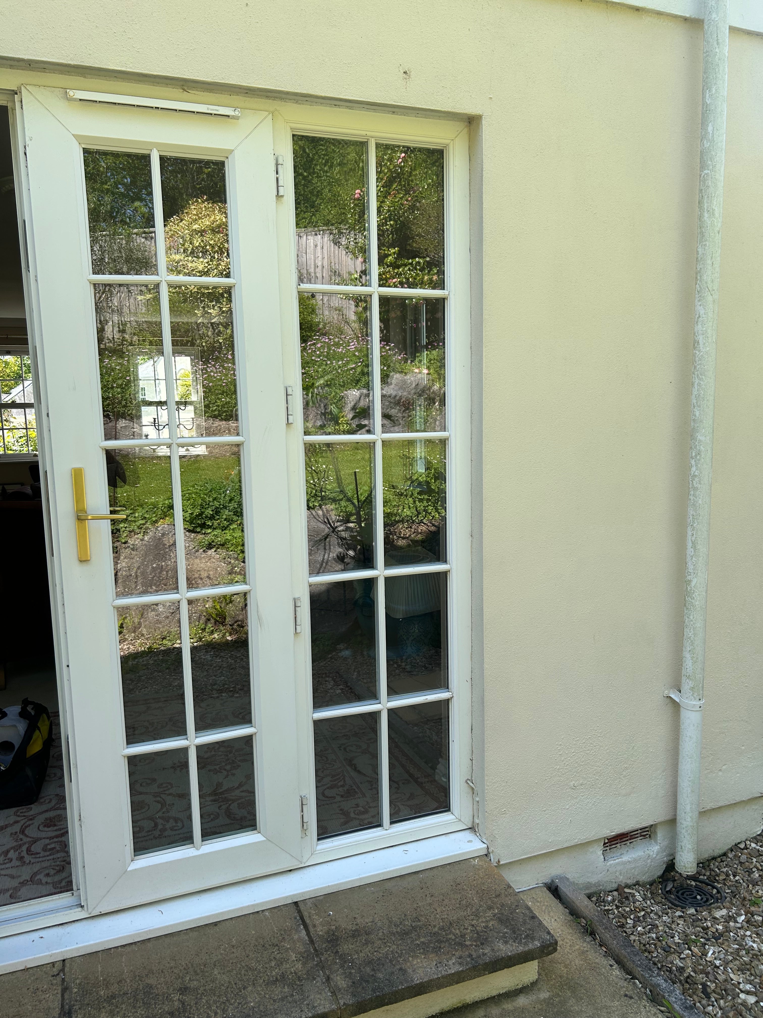White window with grid pattern on a beige wall